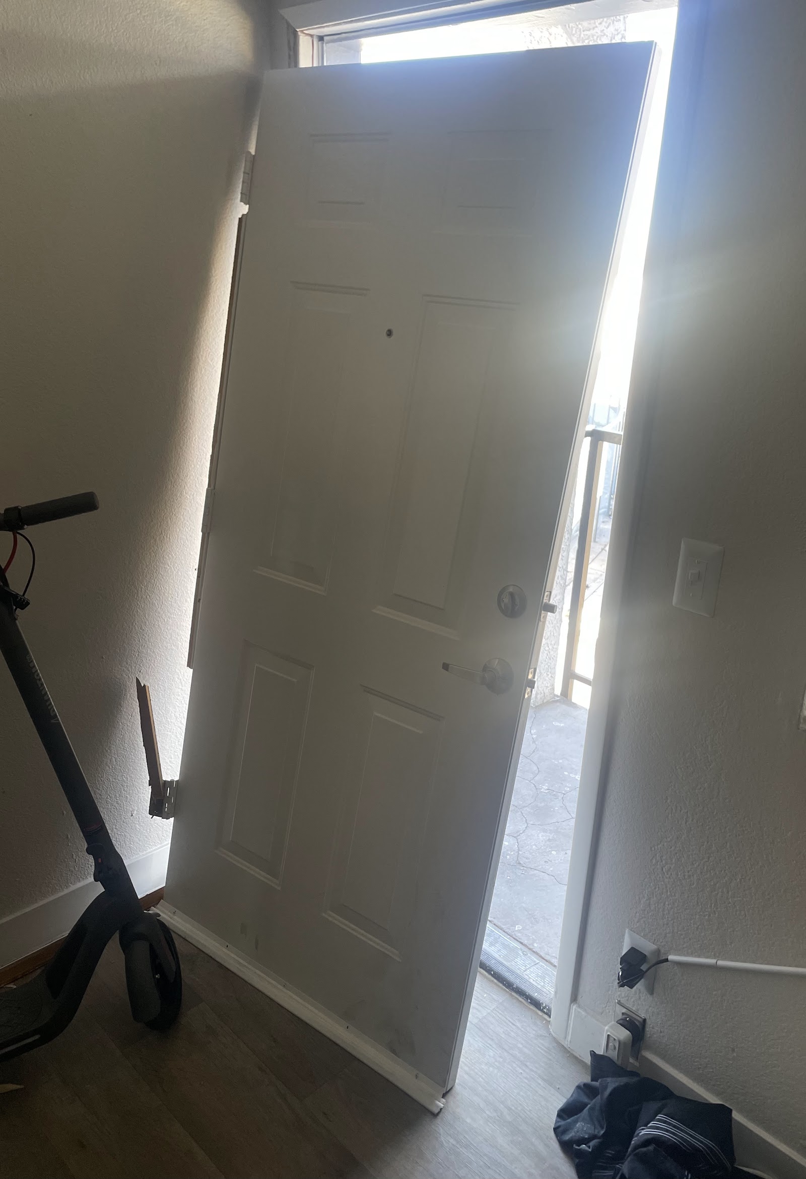Interior entryway with a newly installed white six-panel front door